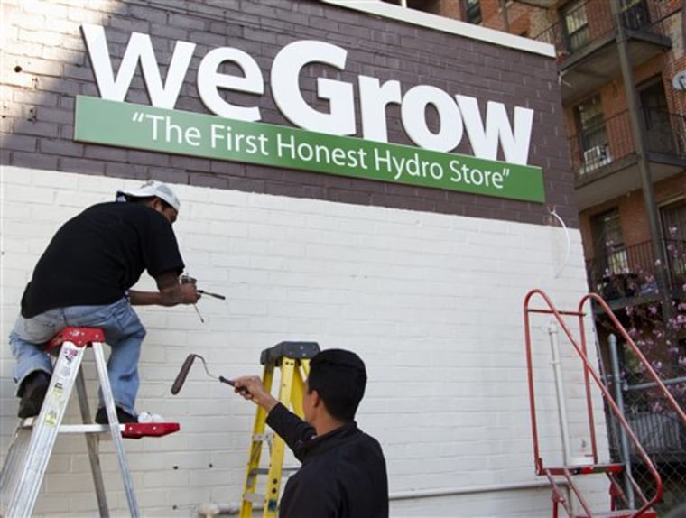 Workers puts on the finishing touches to WeGrow store in northeast Washington, Thursday, March 29, 2012, in preparation for its Friday opening. 